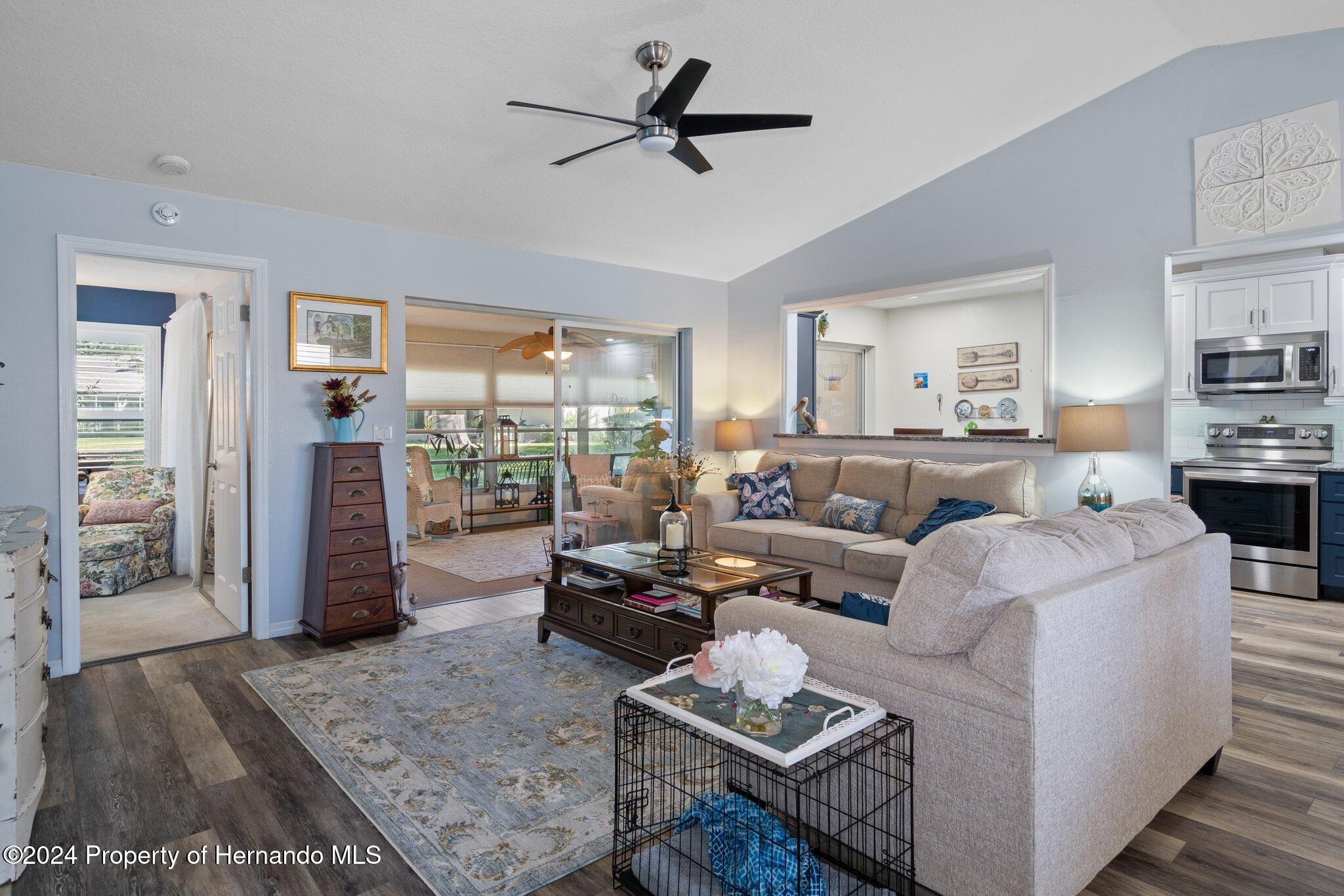 7427 Heather Walk Drive Spring Hill, FL 34613 - Photo 14 of 36 a living room with furniture and a large window