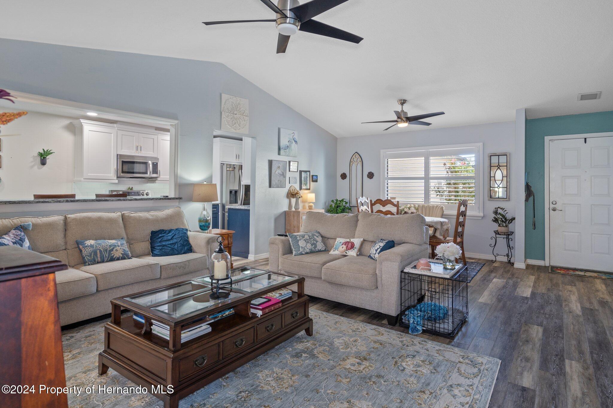 7427 Heather Walk Drive Spring Hill, FL 34613 - Photo 15 of 36 a living room with furniture and a wooden floor