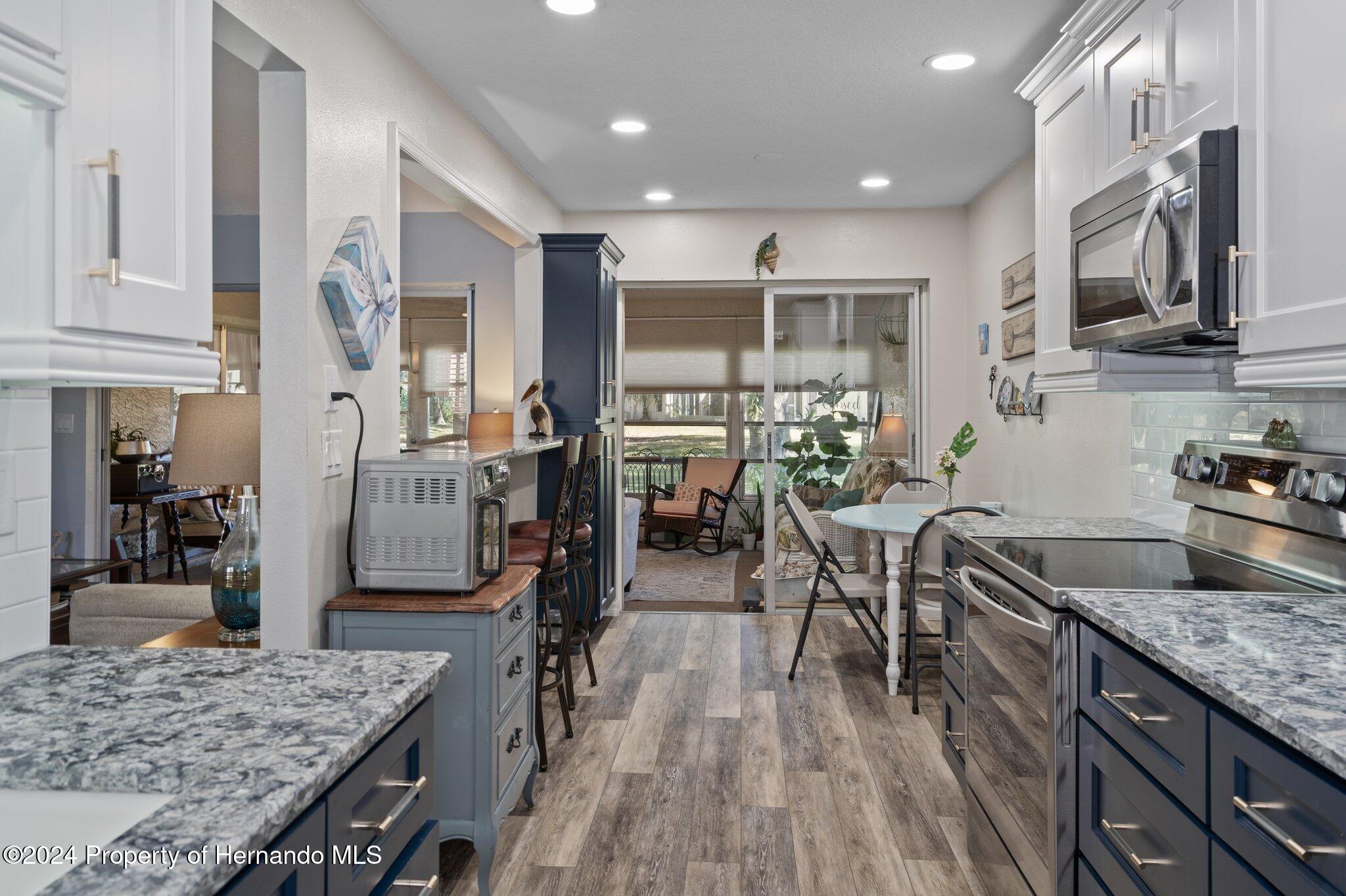 7427 Heather Walk Drive Spring Hill, FL 34613 - Photo 20 of 36 a kitchen with lots of counter top space and stainless steel appliances