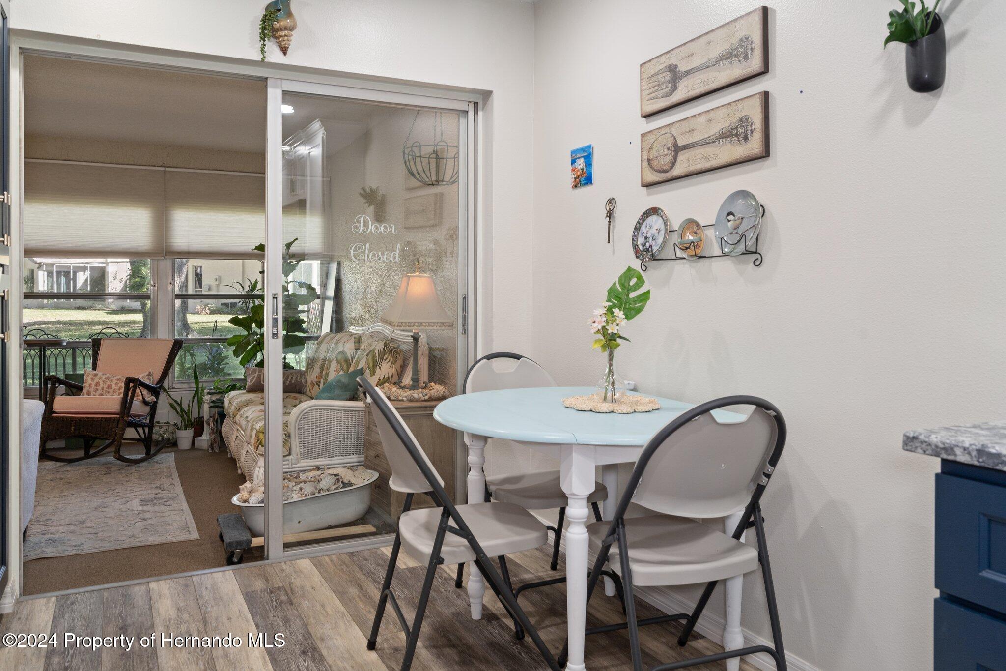 7427 Heather Walk Drive Spring Hill, FL 34613 - Photo 21 of 36 a view of a dining room with furniture and a potted plant