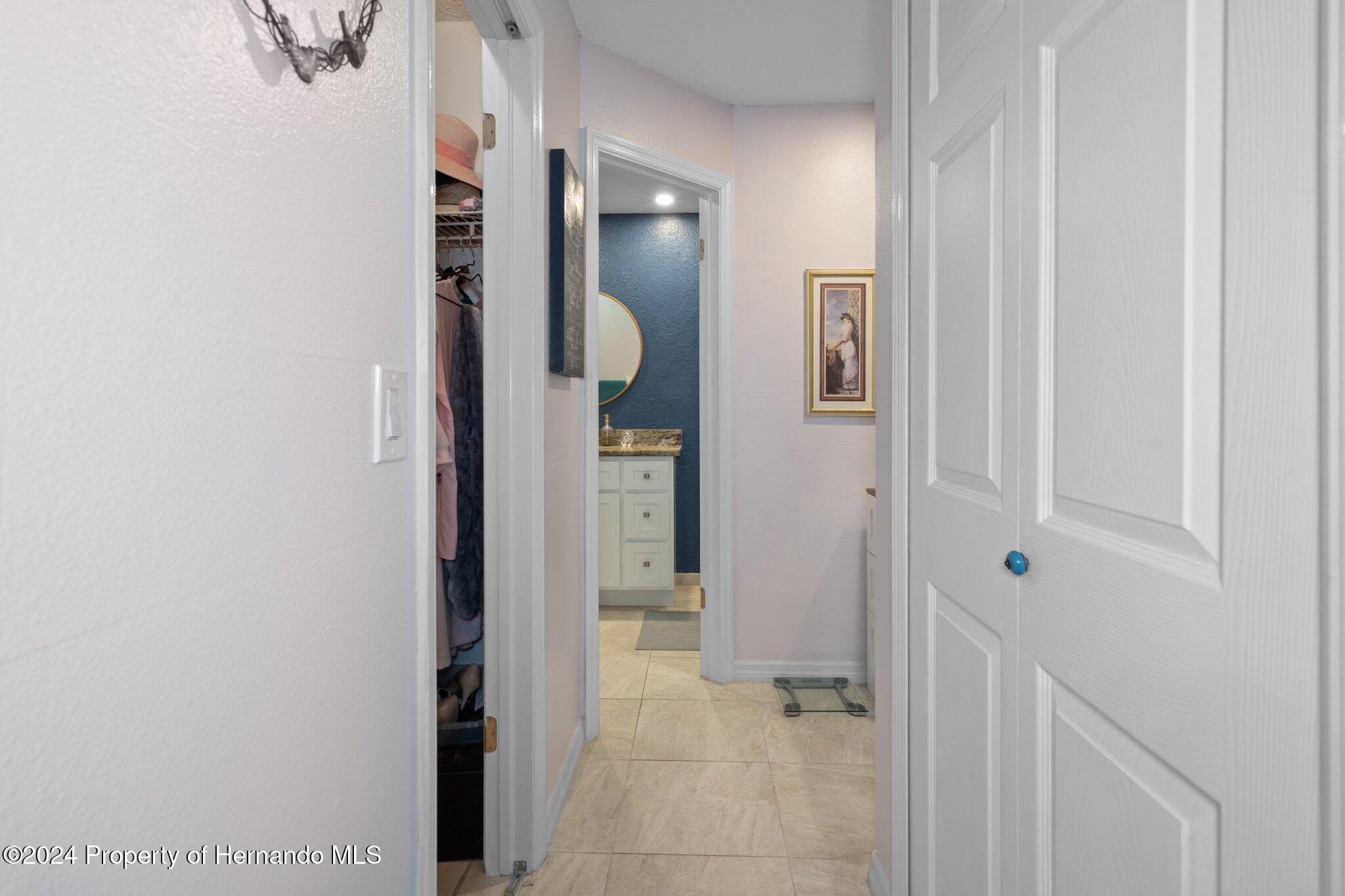 7427 Heather Walk Drive Spring Hill, FL 34613 - Photo 27 of 36 a view of a hallway with wooden floor