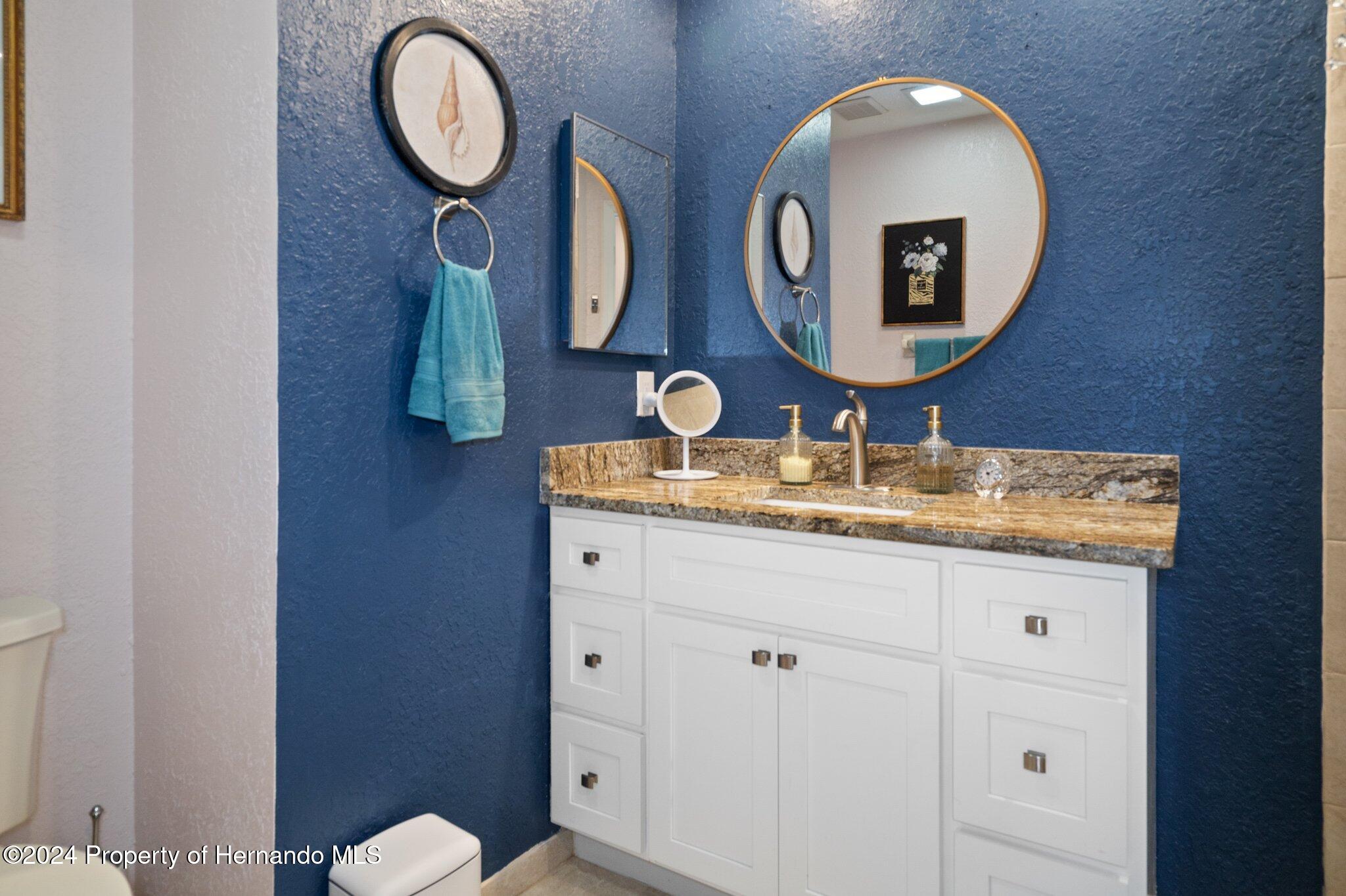 7427 Heather Walk Drive Spring Hill, FL 34613 - Photo 29 of 36 a bathroom with 2 sink and a mirror