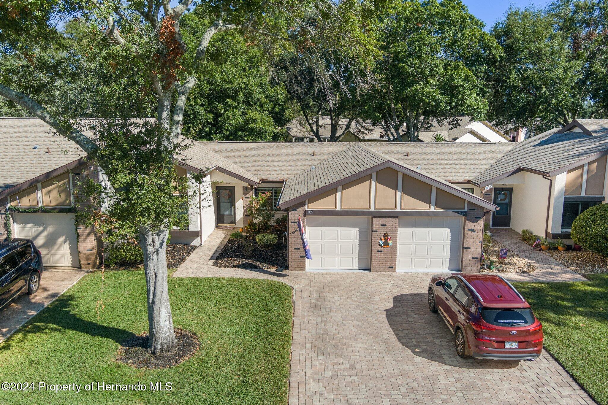 7427 Heather Walk Drive Spring Hill, FL 34613 - Photo 3 of 36 a house view with a outdoor space