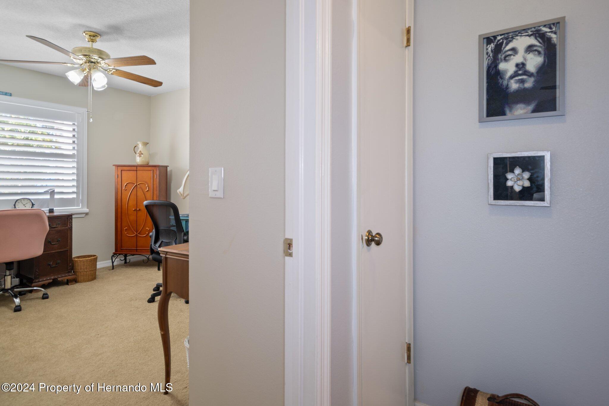 7427 Heather Walk Drive Spring Hill, FL 34613 - Photo 31 of 36 a view of a workspace with furniture and a window