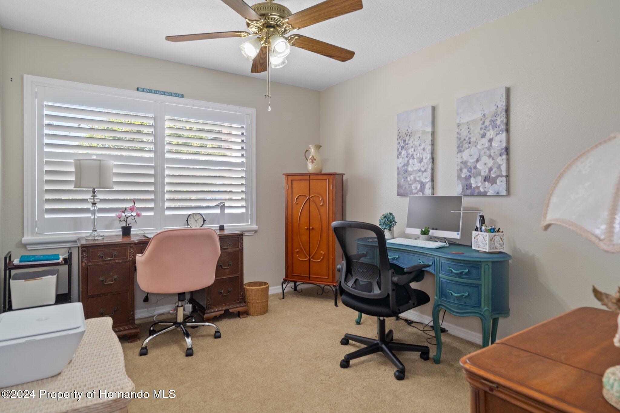 7427 Heather Walk Drive Spring Hill, FL 34613 - Photo 32 of 36 a view of a workspace with furniture and a window