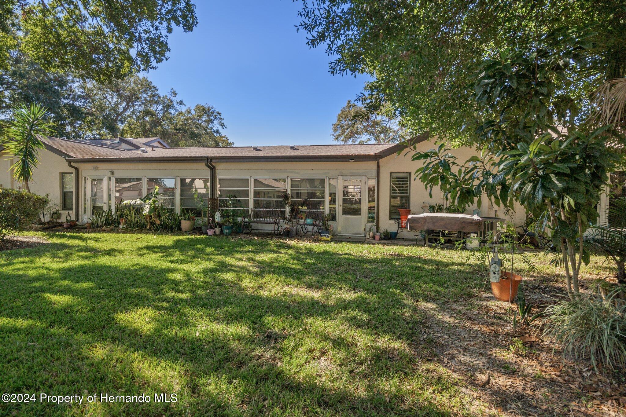 7427 Heather Walk Drive Spring Hill, FL 34613 - Photo 35 of 36 a front view of house with yard and green space
