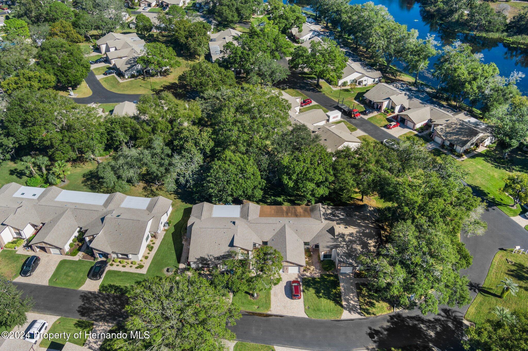 7427 Heather Walk Drive Spring Hill, FL 34613 - Photo 5 of 36 an aerial view of residential house with outdoor space and trees all around
