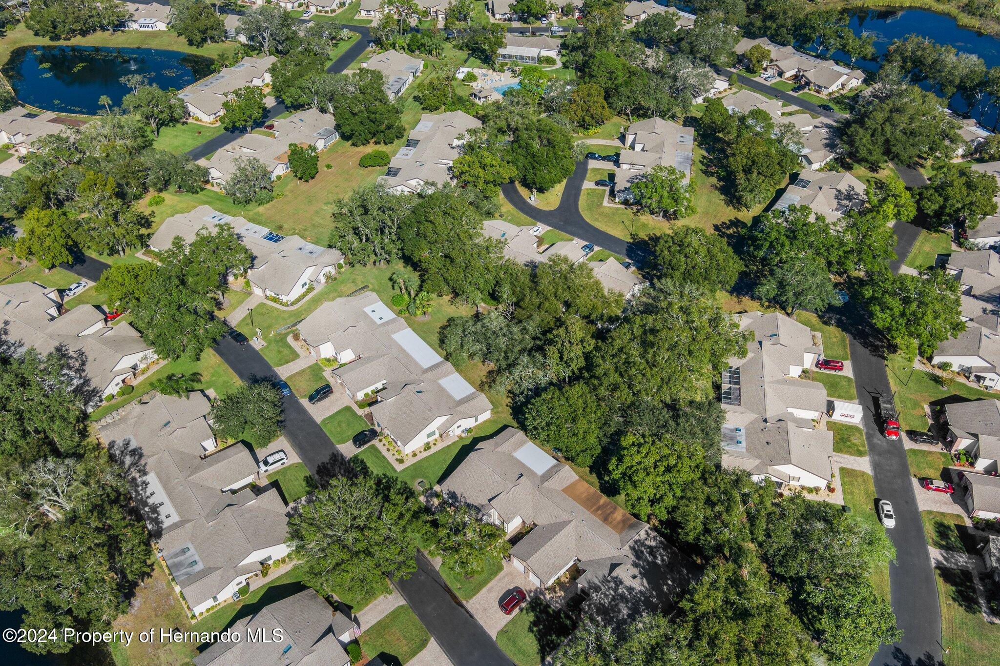 7427 Heather Walk Drive Spring Hill, FL 34613 - Photo 7 of 36 an aerial view of a house with a yard and parking spaces