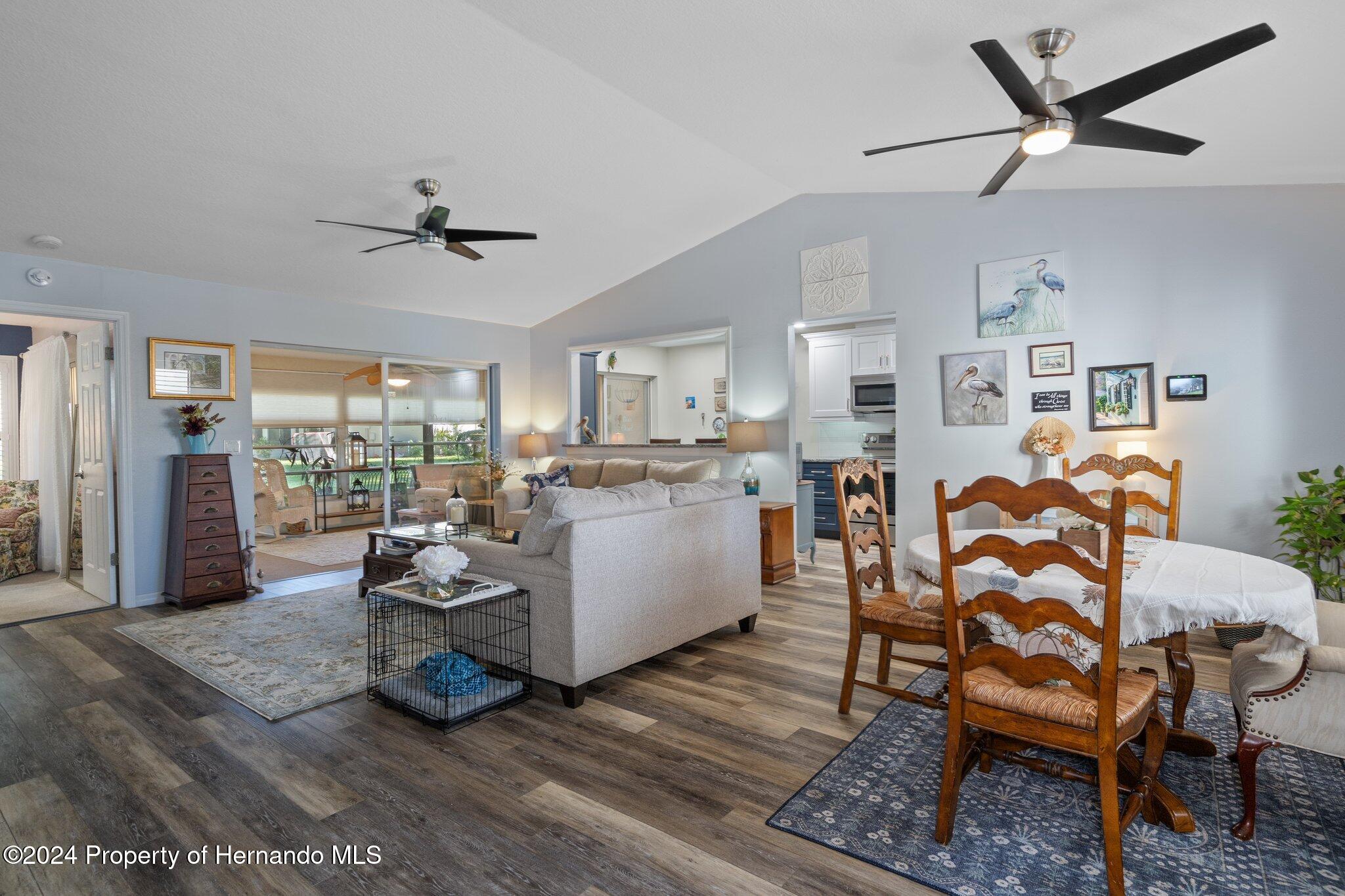 7427 Heather Walk Drive Spring Hill, FL 34613 - Photo 10 of 36 a living room with furniture and kitchen view