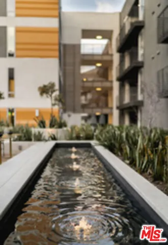 a living room with kitchen island stainless steel appliances and a counter