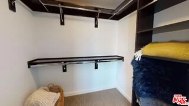 a bedroom with a bed and a walk in closet