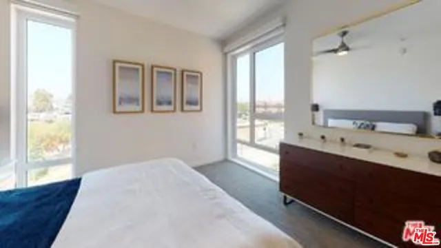 a living room with furniture a flat screen tv and a window