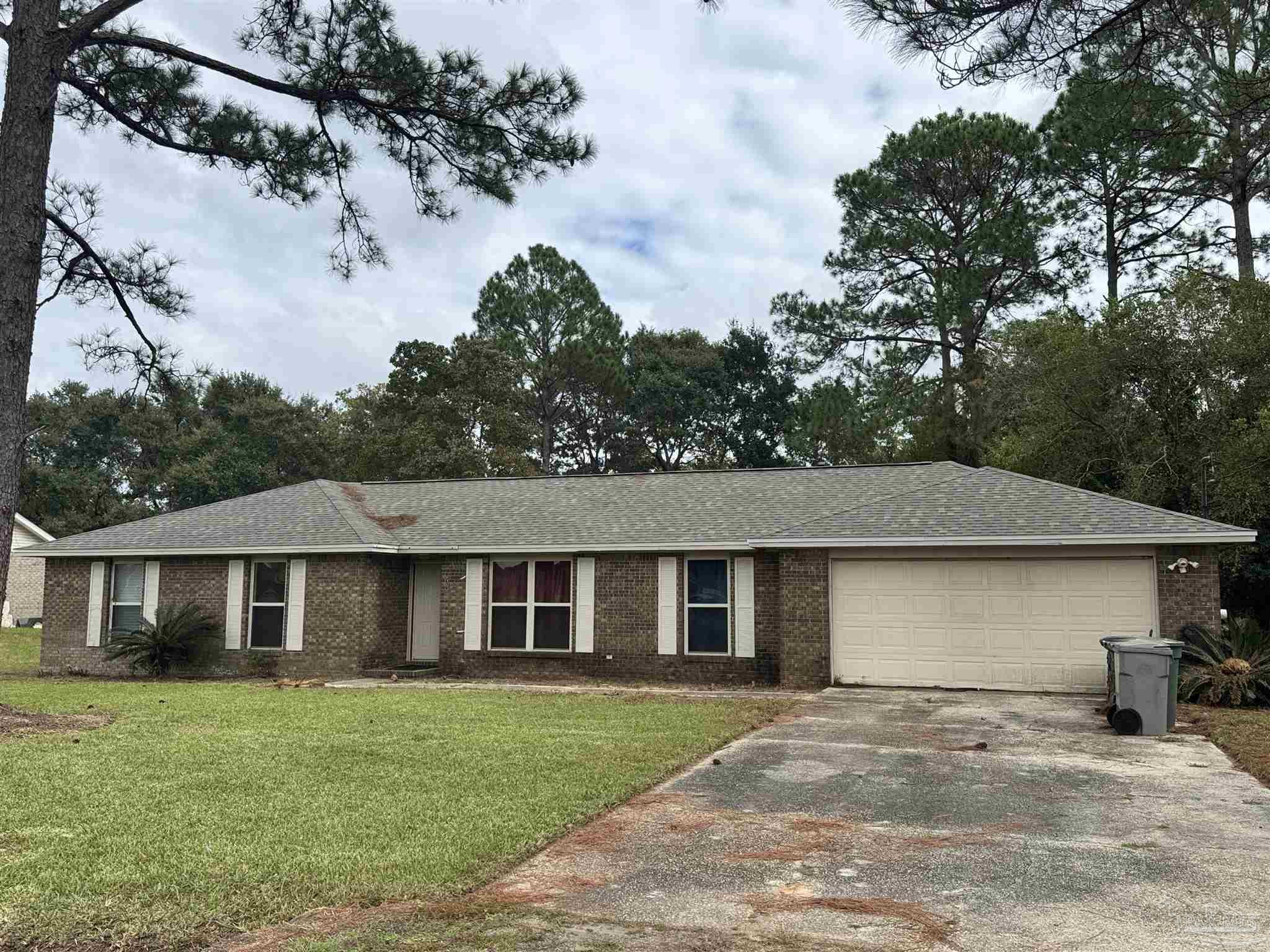 7210 Belgium Road Pensacola, FL 32526 - Photo 1 of 37 a view of a yard in front of a house with large tree