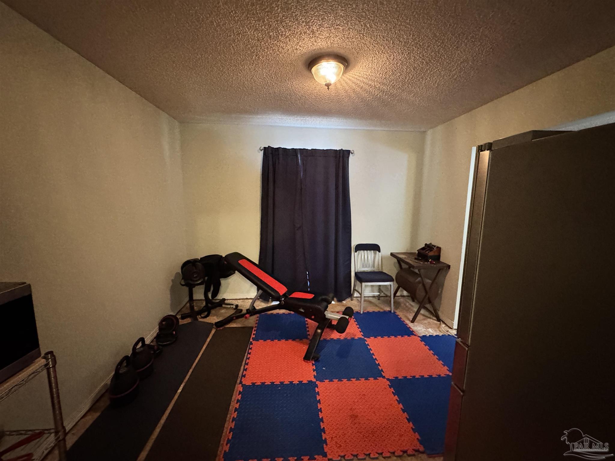 7210 Belgium Road Pensacola, FL 32526 - Photo 11 of 37 a room with furniture and gym equipment
