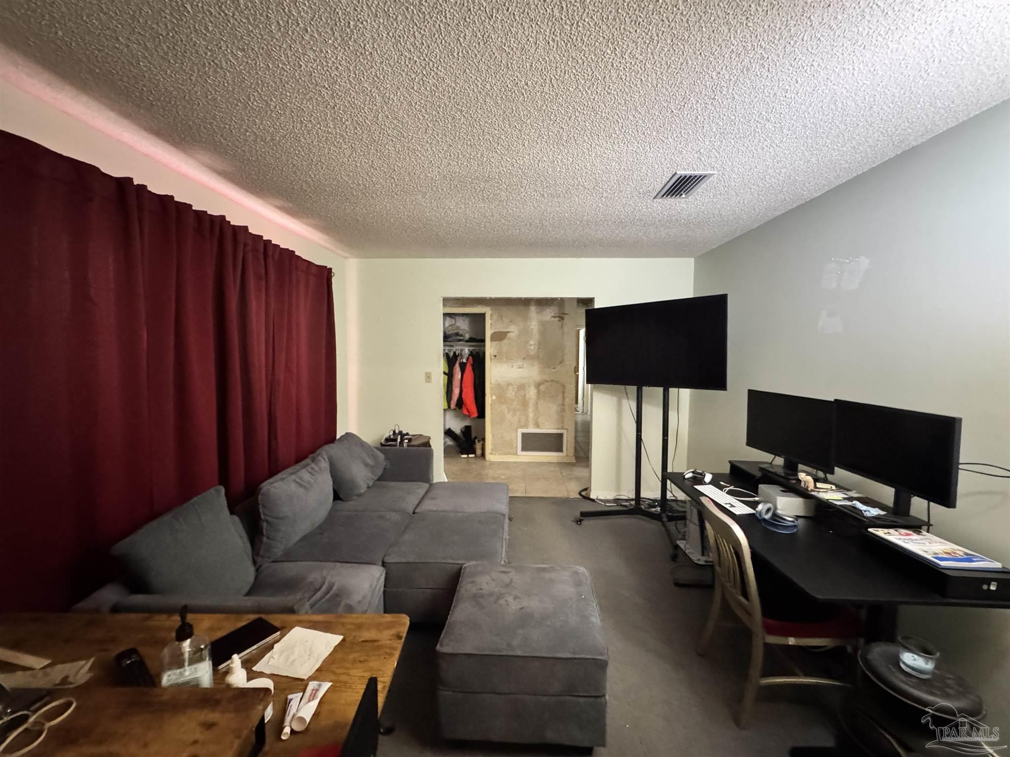 7210 Belgium Road Pensacola, FL 32526 - Photo 12 of 37 a living room with furniture and a flat screen tv