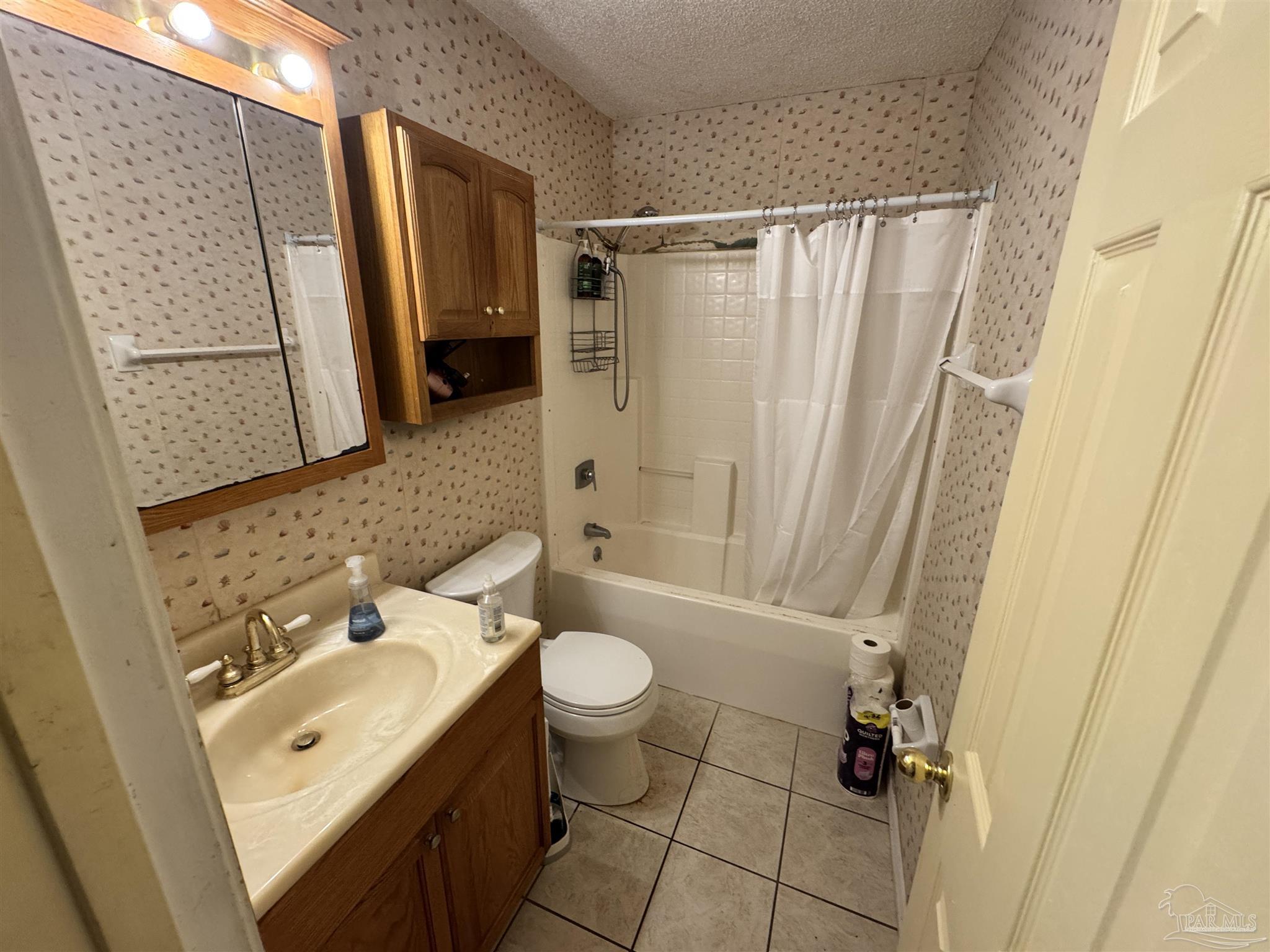 7210 Belgium Road Pensacola, FL 32526 - Photo 13 of 37 a bathroom with a sink a toilet a mirror and shower
