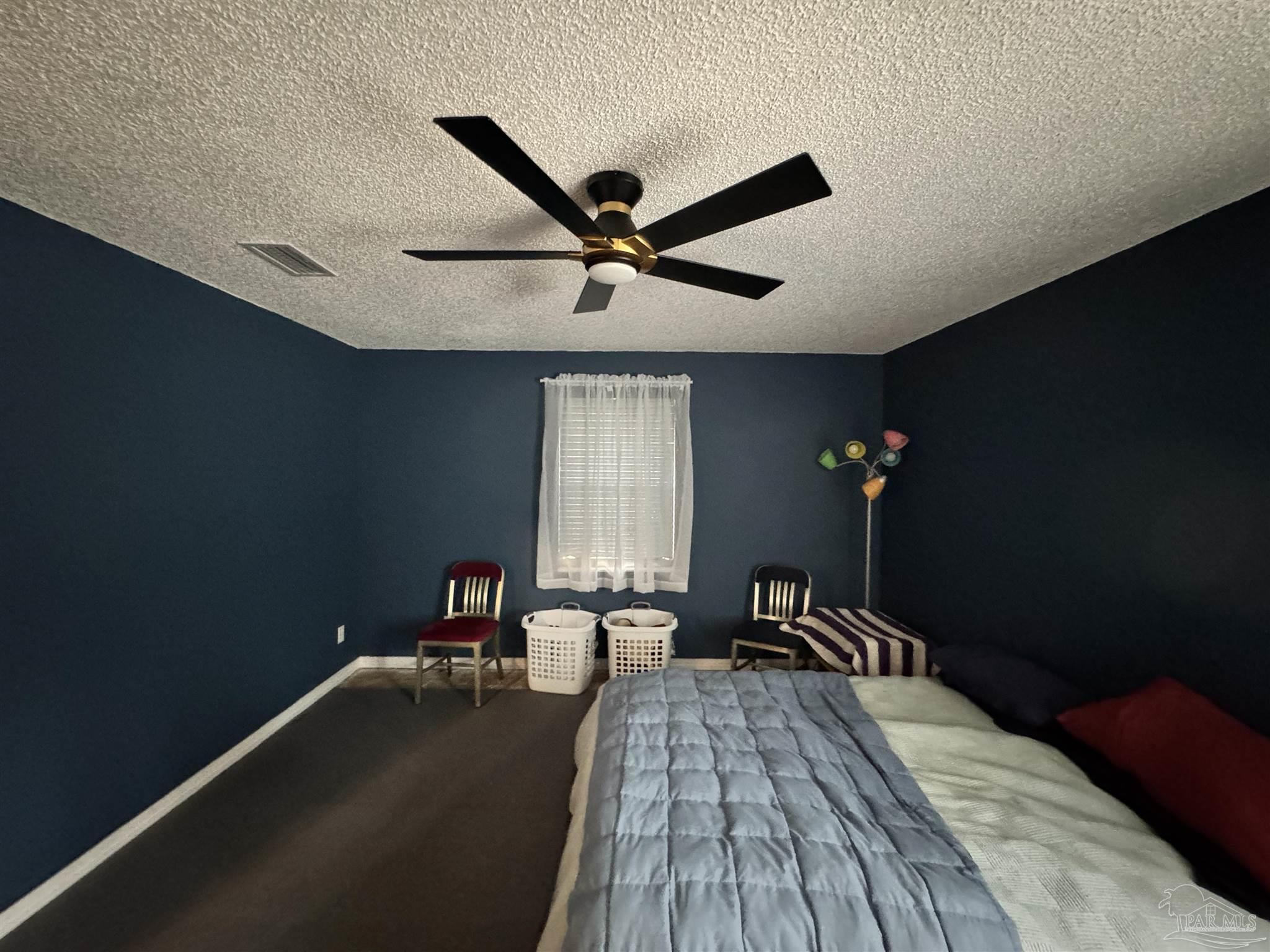 7210 Belgium Road Pensacola, FL 32526 - Photo 15 of 37 a bed room with a bed and a chandelier