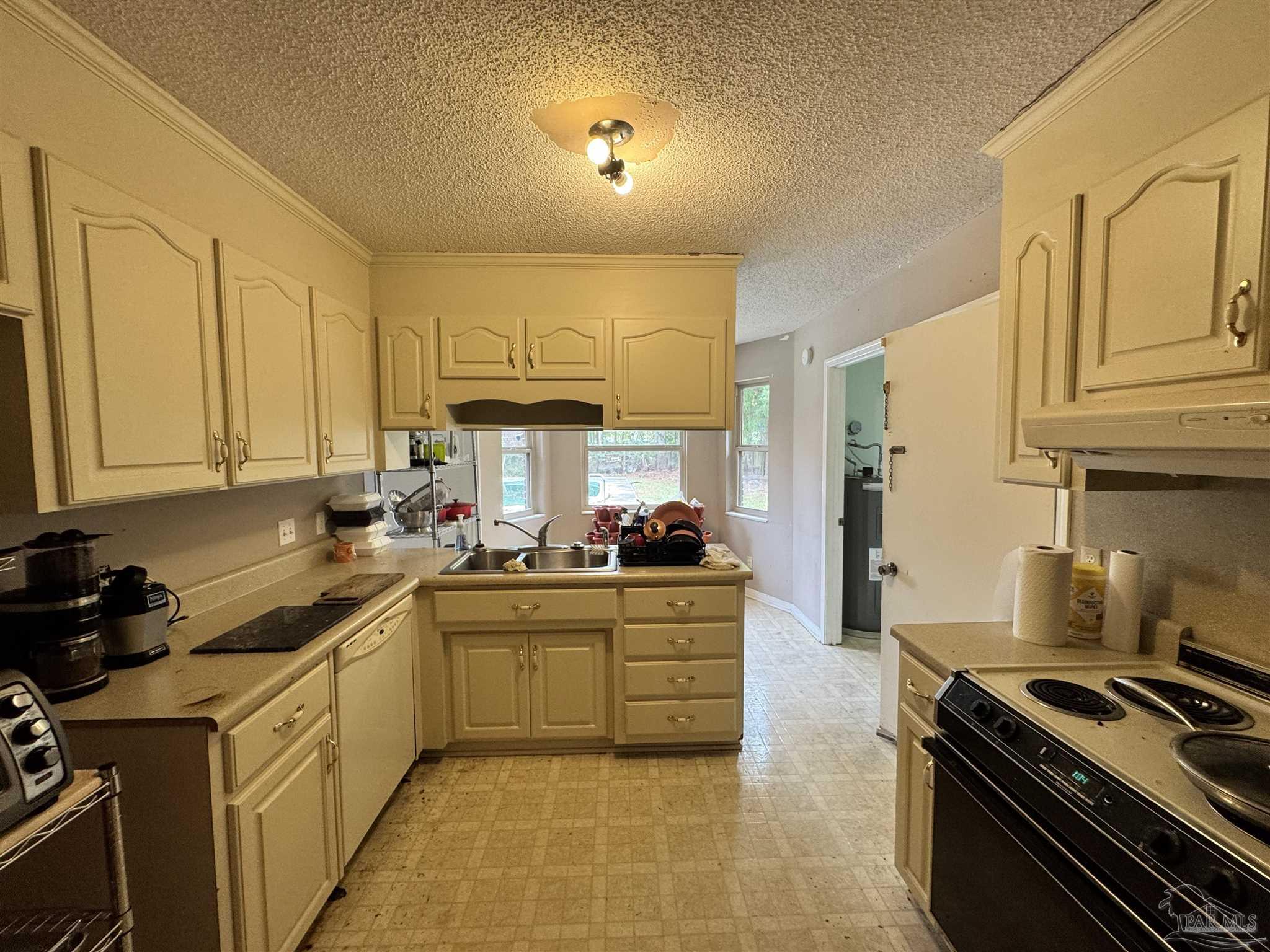 7210 Belgium Road Pensacola, FL 32526 - Photo 3 of 37 a kitchen with a sink stove and cabinets