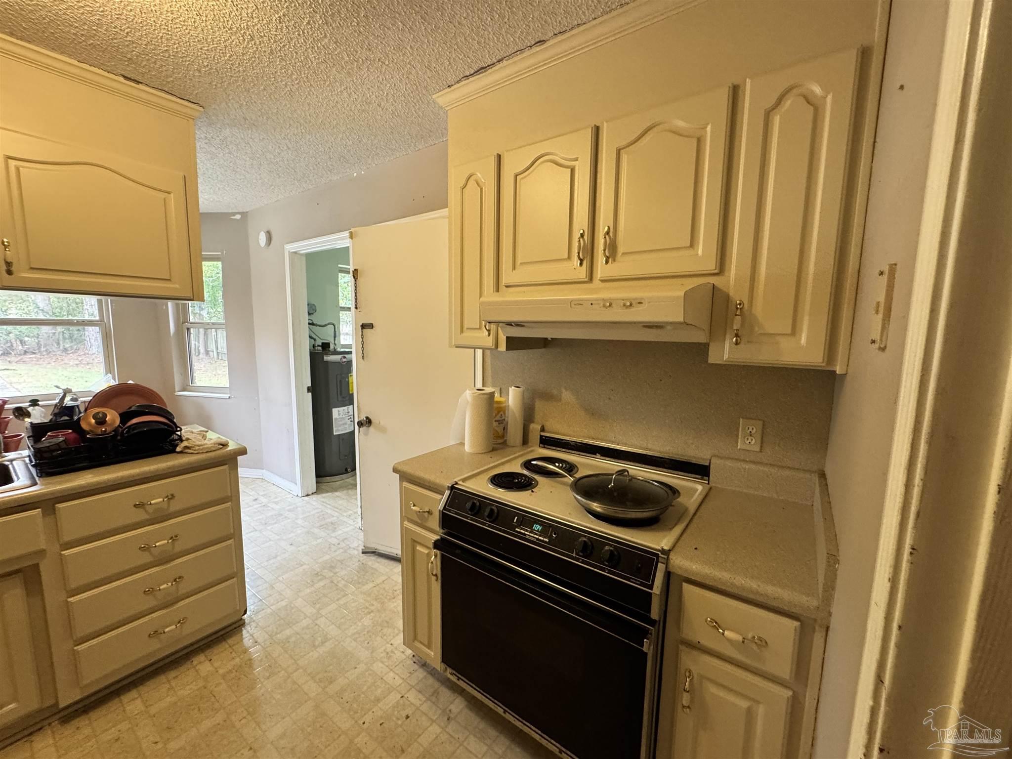 7210 Belgium Road Pensacola, FL 32526 - Photo 4 of 37 a kitchen with stainless steel appliances granite countertop a stove and a refrigerator