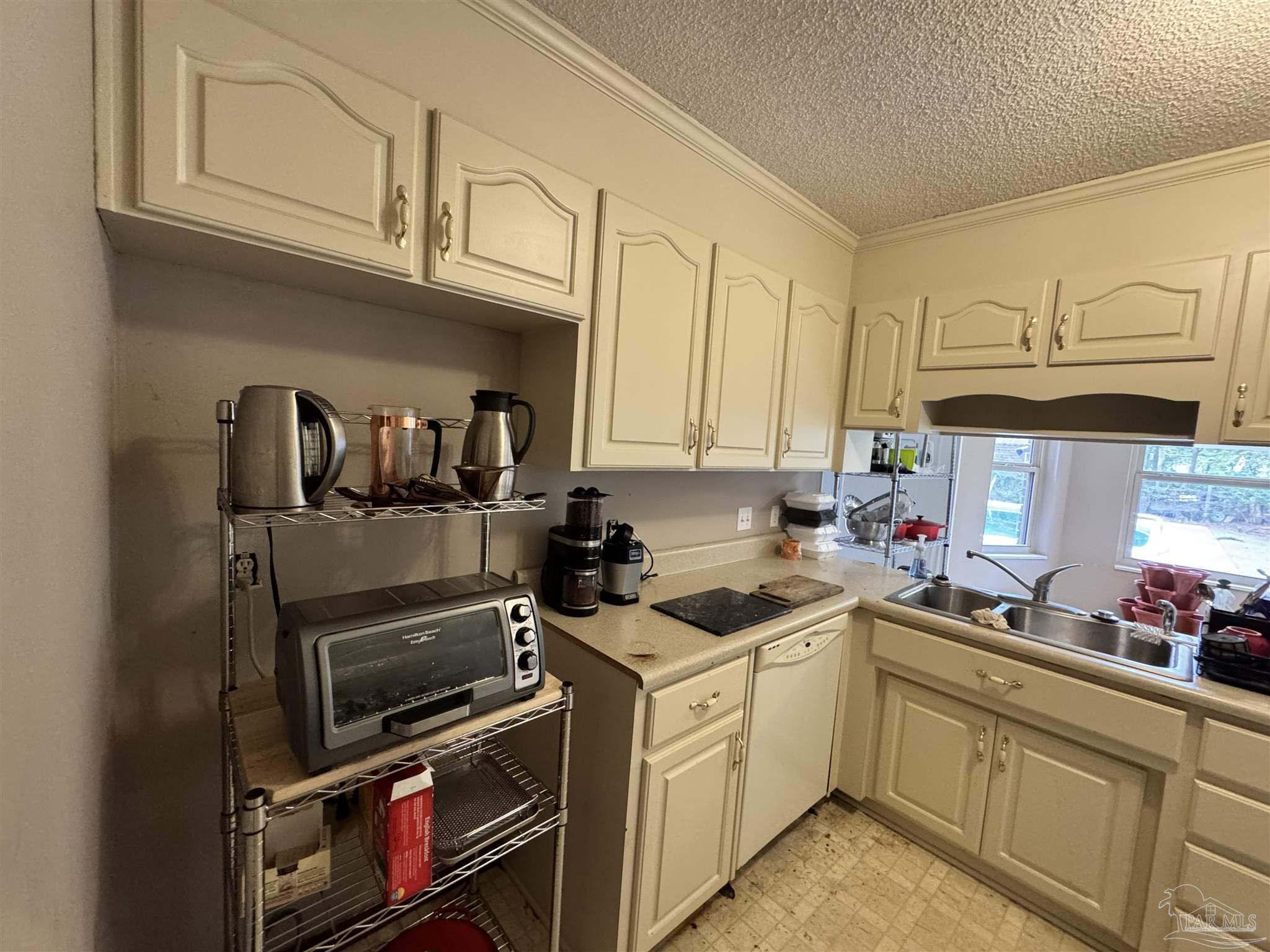 7210 Belgium Road Pensacola, FL 32526 - Photo 5 of 37 a kitchen with stainless steel appliances granite countertop a stove a sink and a microwave