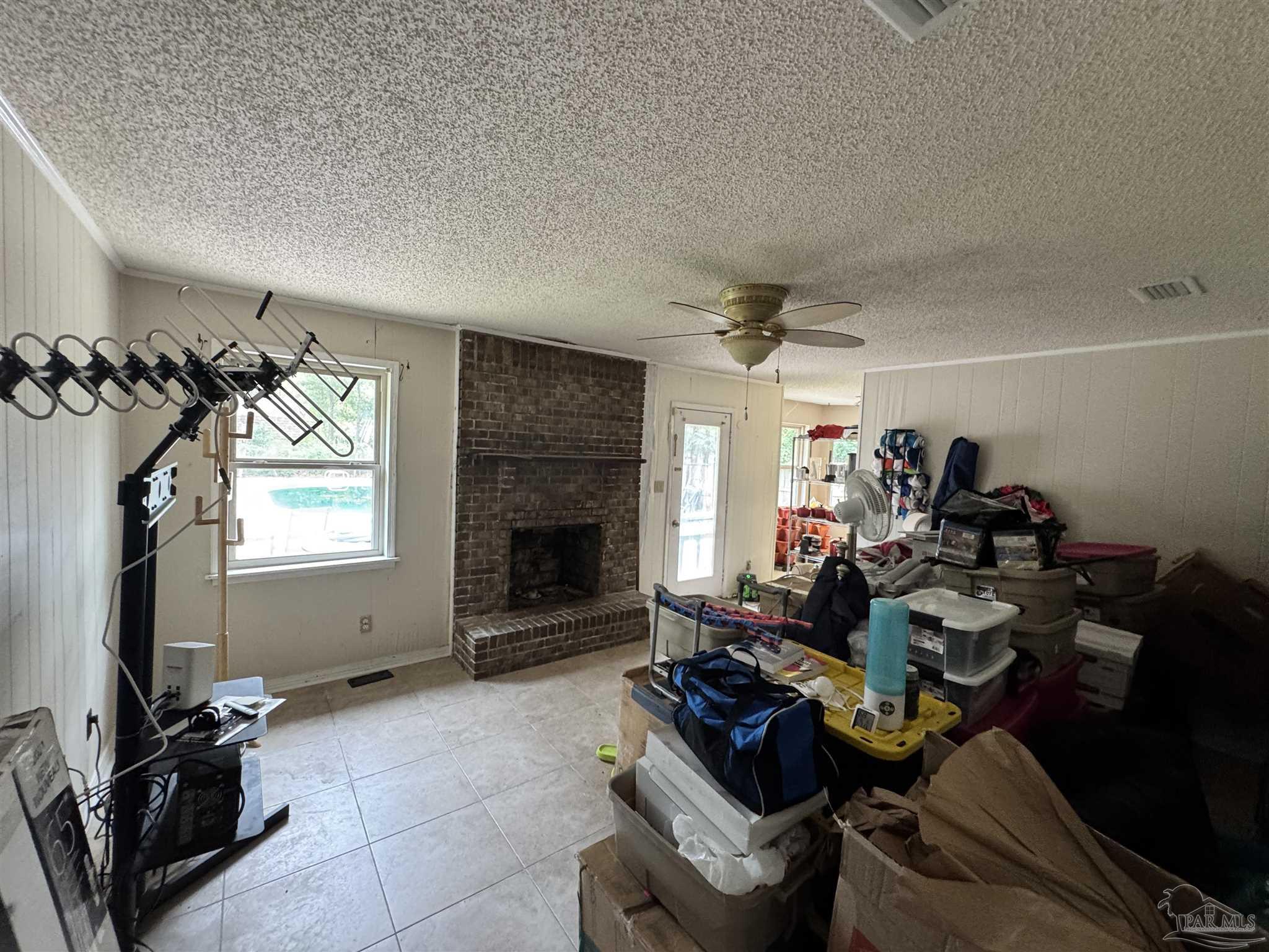 7210 Belgium Road Pensacola, FL 32526 - Photo 8 of 37 a living room with furniture a flat screen tv and a fireplace