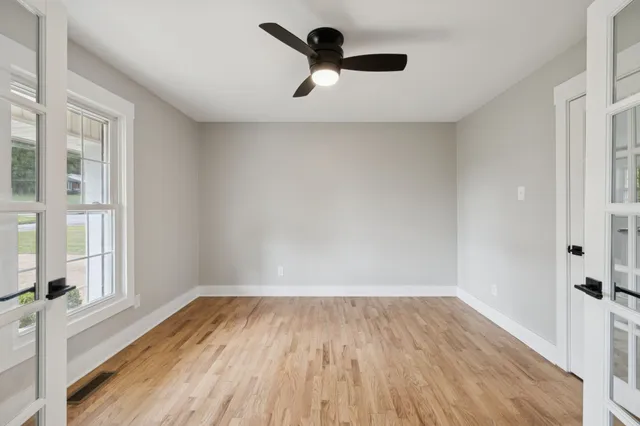 wooden floor in an empty room with a window