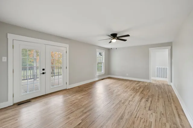 a kitchen with granite countertop sink window and white stainless steel appliances