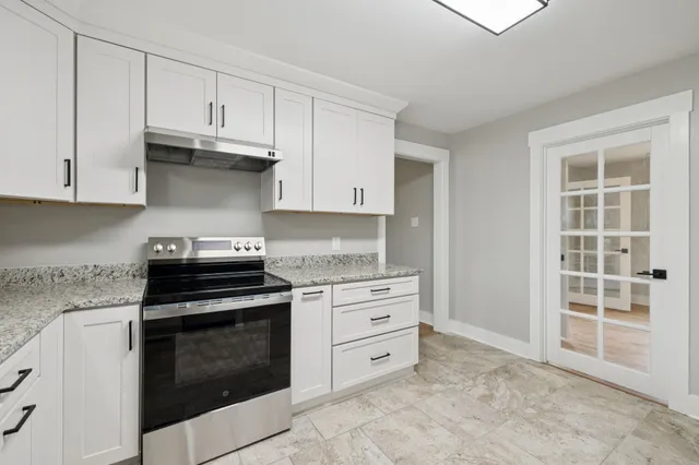 a kitchen with stainless steel appliances granite countertop a sink and cabinets