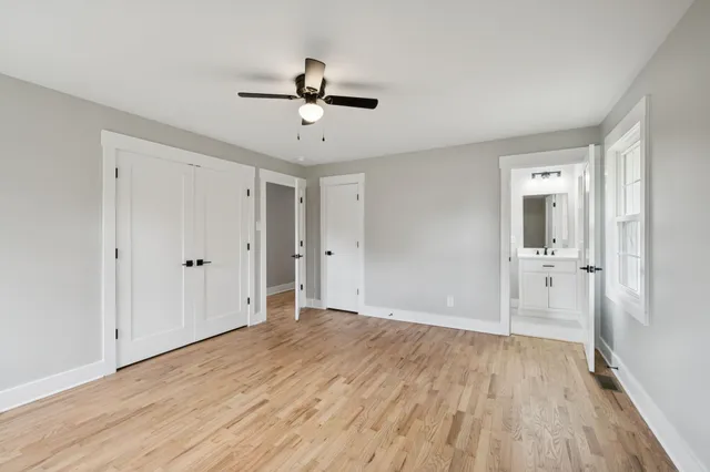 a bathroom with a toilet a sink a mirror a bathtub and vanity