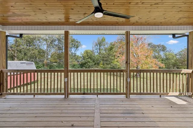 a balcony with wooden floor and furniture