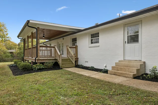 a view of a yard with a house in the background