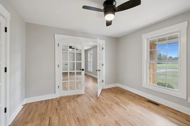wooden floor in an empty room with a window