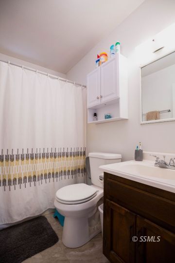 122 South Valley Street Ridgecrest, CA 93555 - Photo 22 of 26 a bathroom with a sink a toilet and a shower