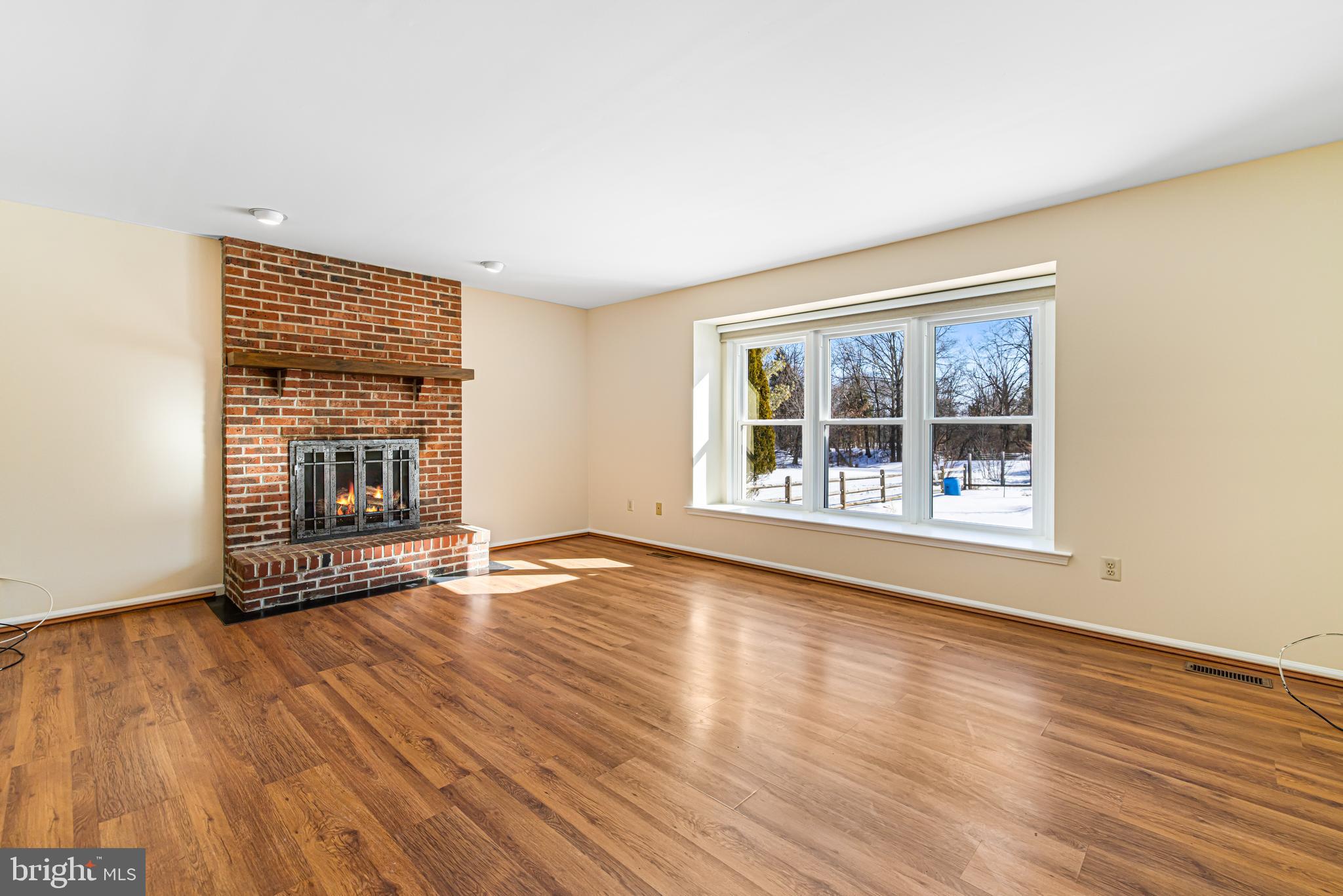 2249 Lilac Lane Jamison, PA 18929 - Photo 16 of 61 a view of an empty room with wooden floor and a window