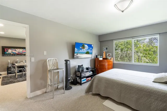 a bed room with a bed and a large window