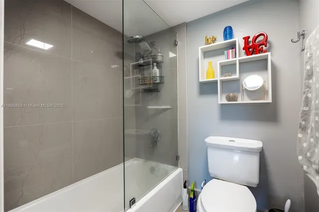 a bathroom with a toilet and a shower