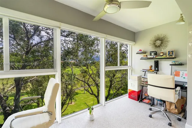 a bedroom with furniture and a large window