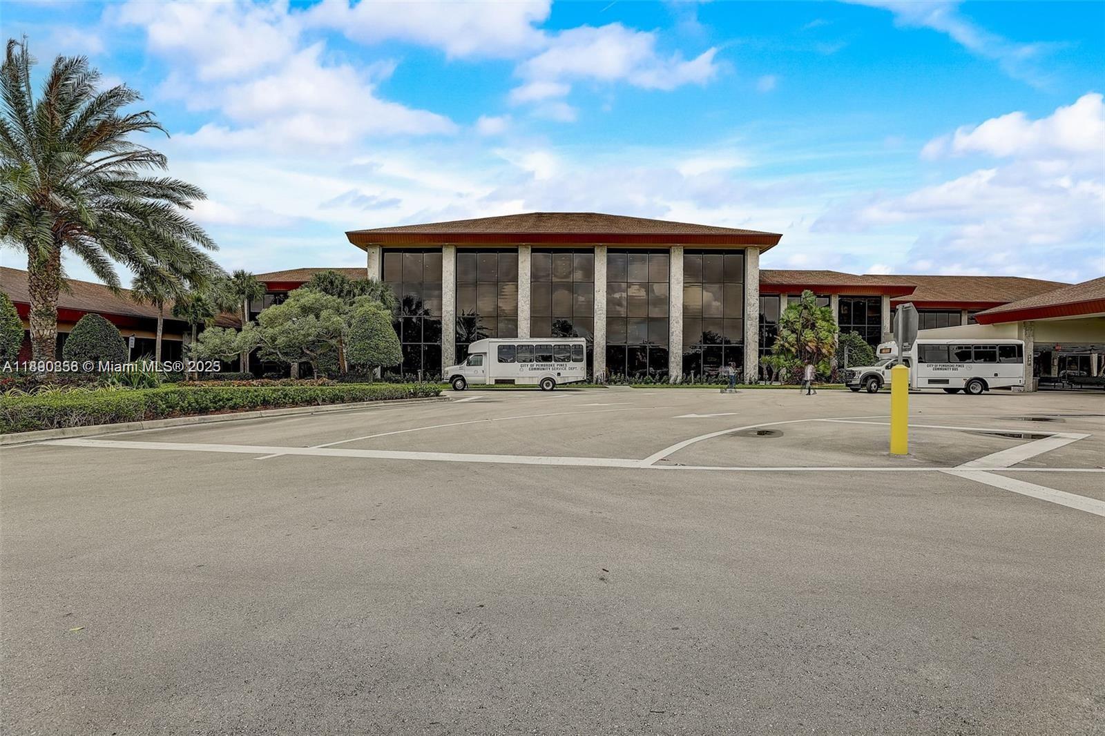 1201 Southwest 128th Terrace, Unit 407E Pembroke Pines, FL 33027 - Photo 22 of 26 a front view of building with small garden