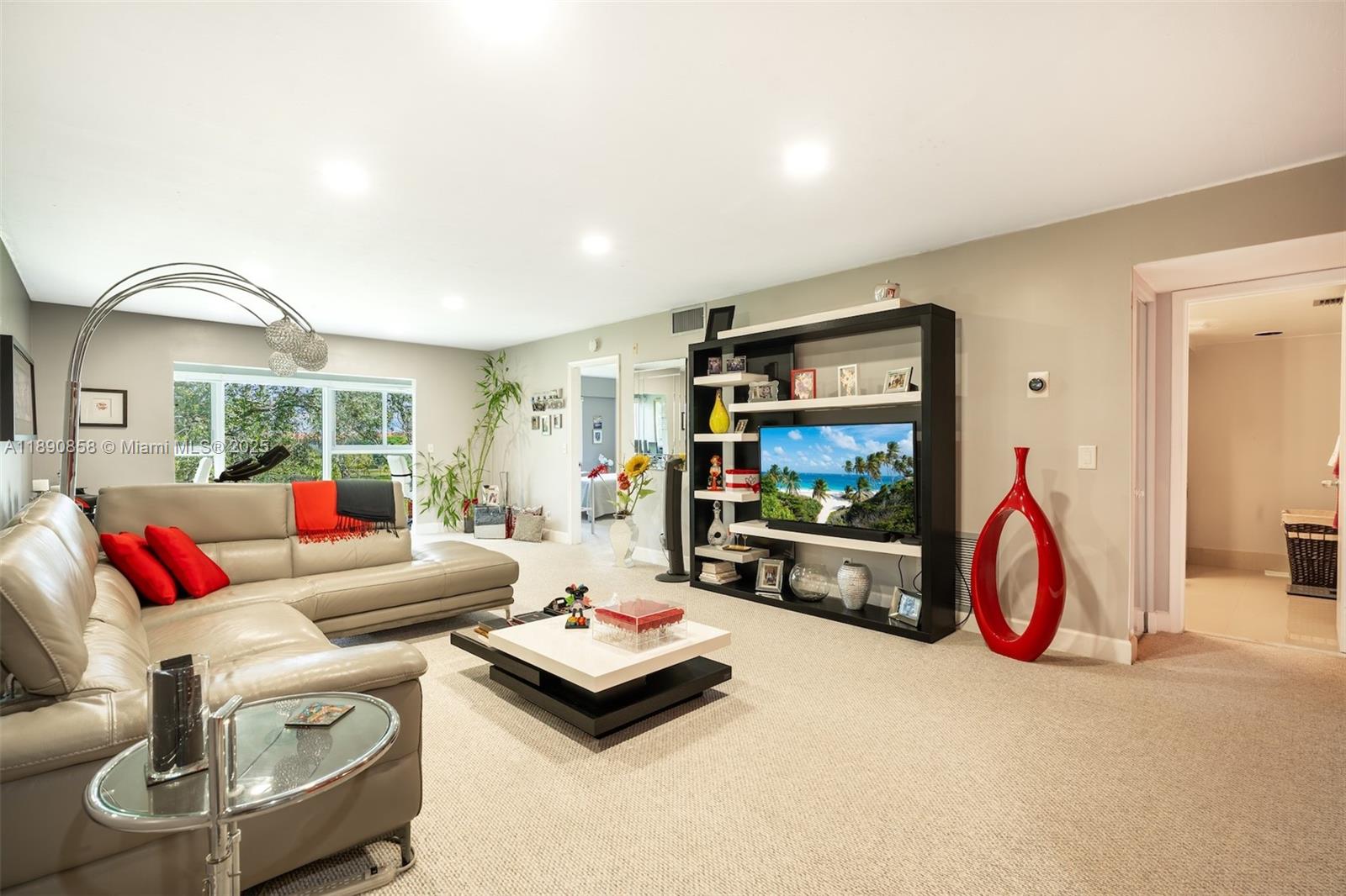 1201 Southwest 128th Terrace, Unit 407E Pembroke Pines, FL 33027 - Photo 3 of 26 a living room with furniture a flat screen tv and a white floor