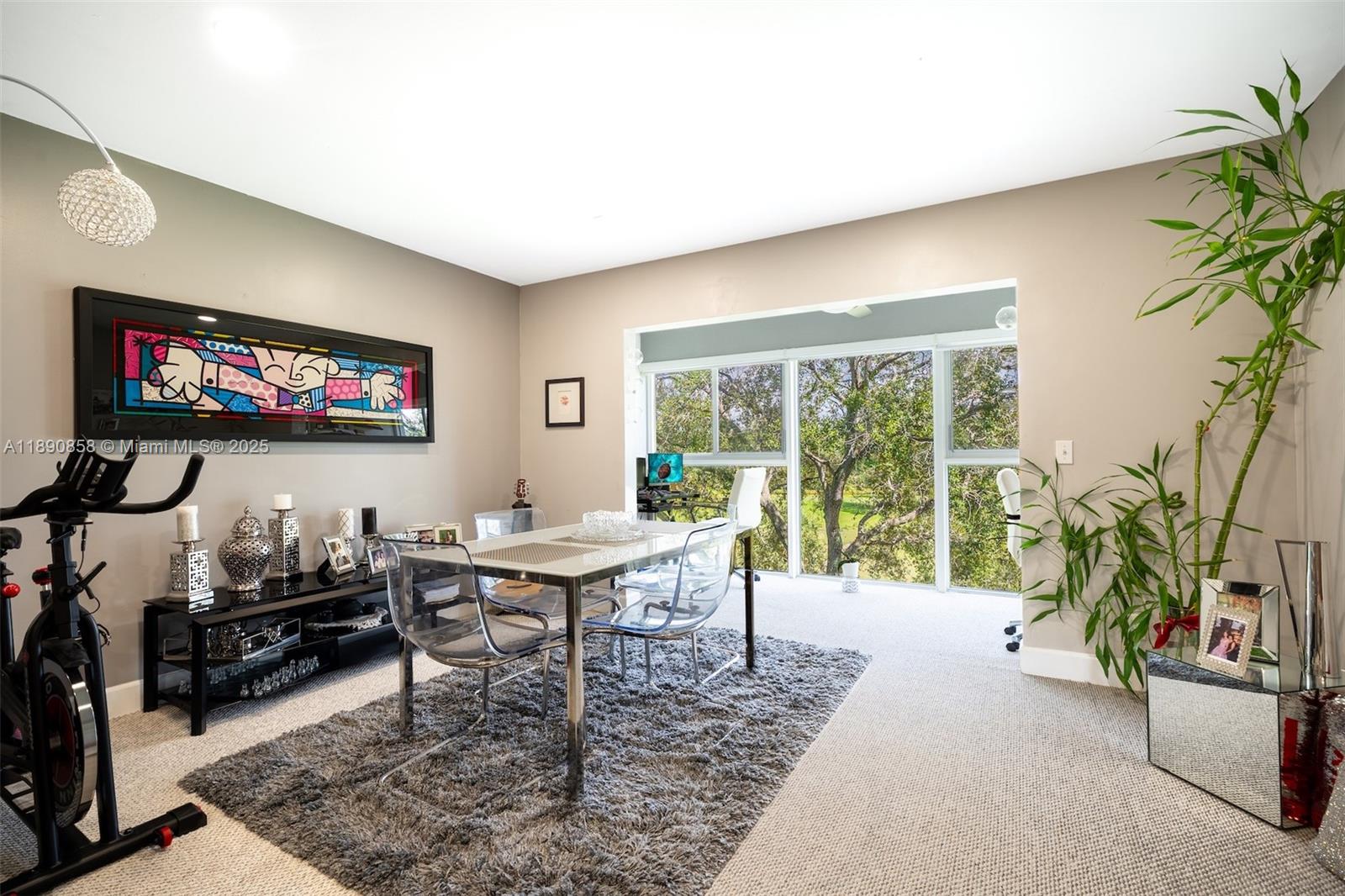 1201 Southwest 128th Terrace, Unit 407E Pembroke Pines, FL 33027 - Photo 6 of 26 a workspace with furniture and a potted plant