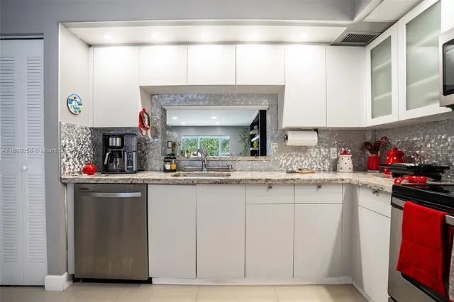 a kitchen with stainless steel appliances granite countertop a sink and cabinets