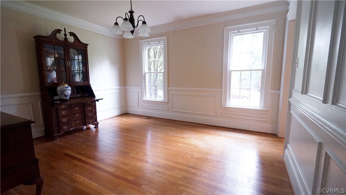 Dining room features hardwoods, chair rail molding