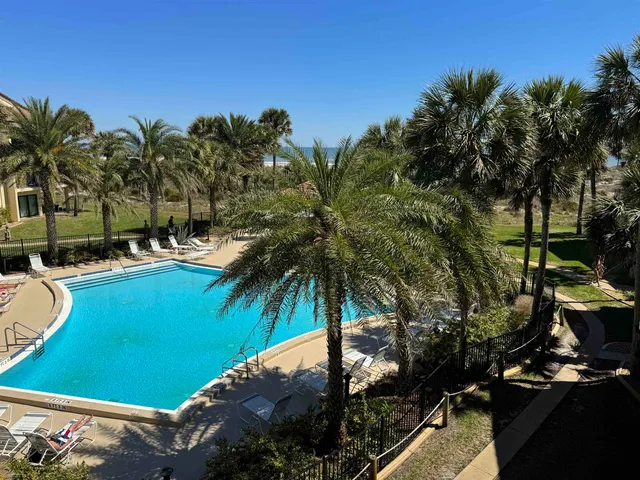 a kitchen with stainless steel appliances a sink a stove a microwave a sink a refrigerator and cabinets