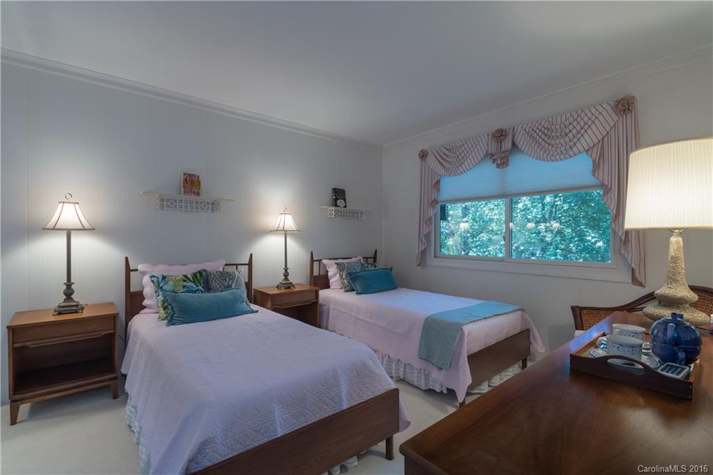 16071 Palawan Court Tega Cay, SC 29708 - Photo 22 of 22 a bedroom with two beds and a lamp