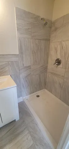 a bathroom with a tub and shower