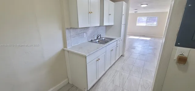 a view of a kitchen from the hallway