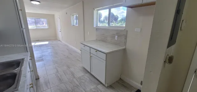 a house with green field in front of it