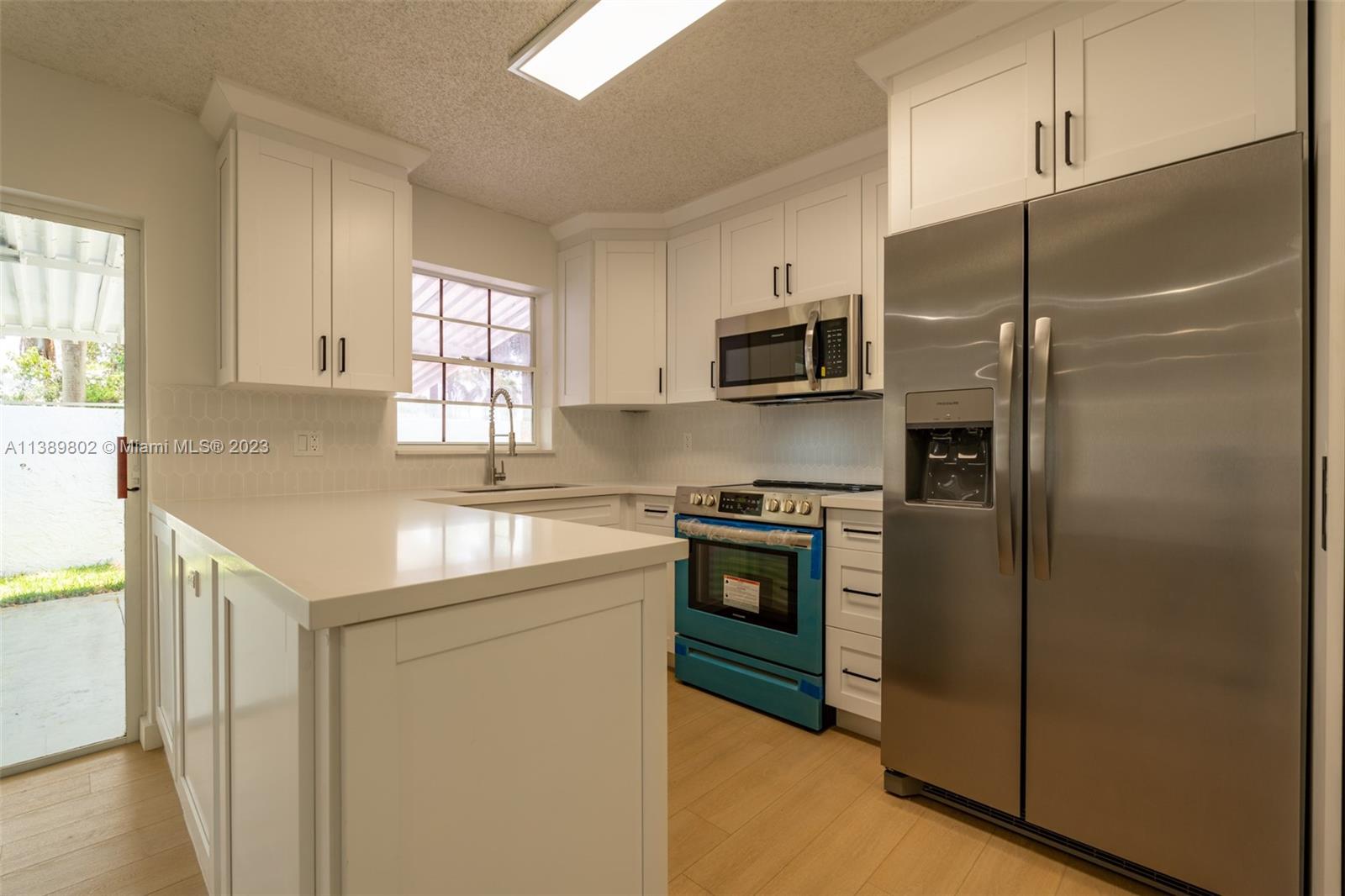 The Hammocks Miami, FL 33196 - Photo 14 of 38 a kitchen with a refrigerator sink and stove