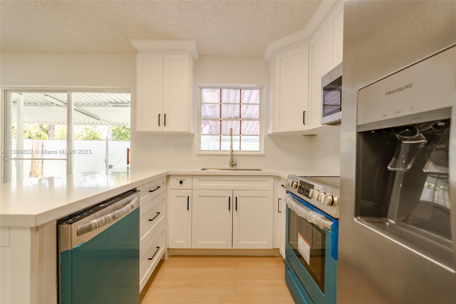 The Hammocks Miami, FL 33196 - Photo 15 of 38 a kitchen with granite countertop white cabinets and white appliances