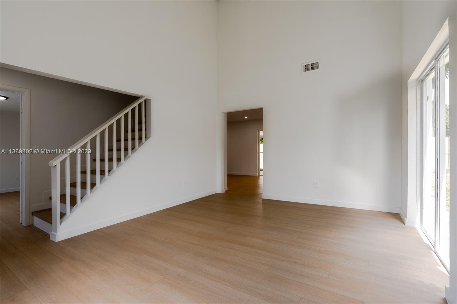 The Hammocks Miami, FL 33196 - Photo 21 of 38 a view of an empty room with wooden floor and windows
